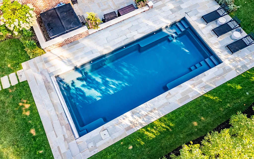 Drone view of a Leisure Pools inground fiberglass pool Locey Swim & Spa: northwest and southwest Michigan's trusted fiberglass pool experts